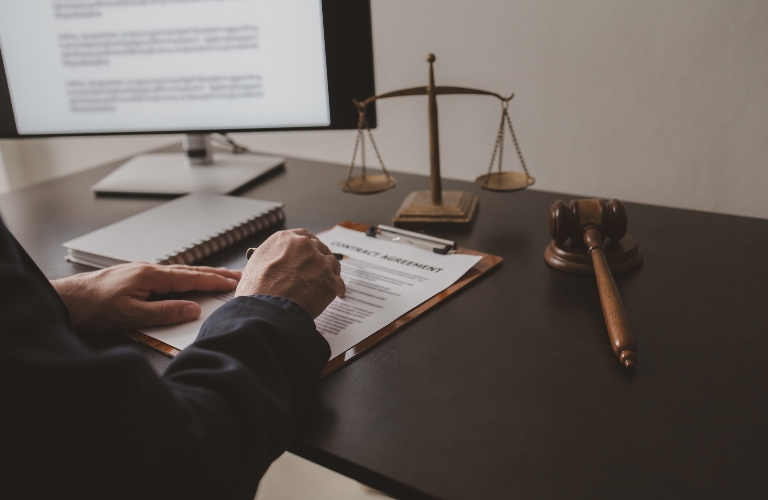 Lawyer sits in office with documents