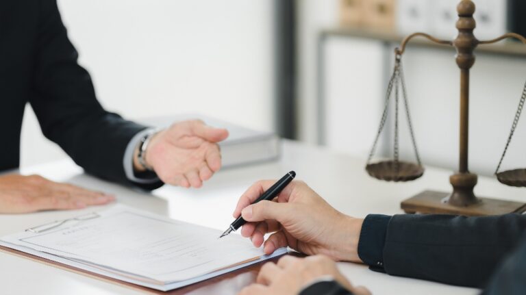 Lawyer is showing client where to sign documents
