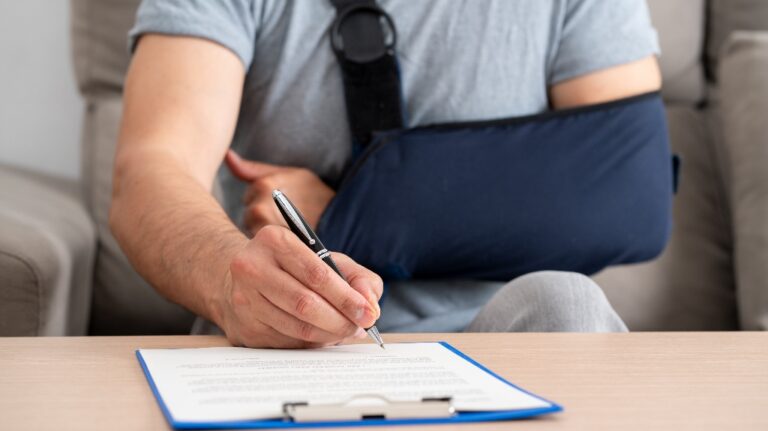 Injured man is signing document